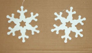 Wooden snowflakes painted white.