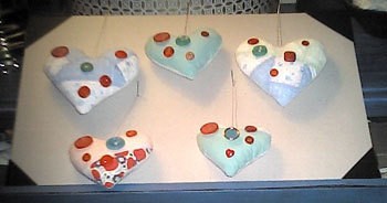 Pieced heart shaped ornaments decorated with buttons.