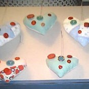 Pieced heart shaped ornaments decorated with buttons.