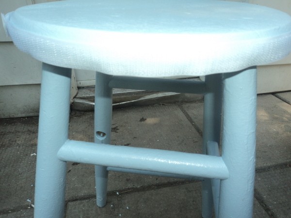 Velcro attached to the wooden stool.