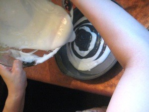 View of several layers and adding more white batter.
