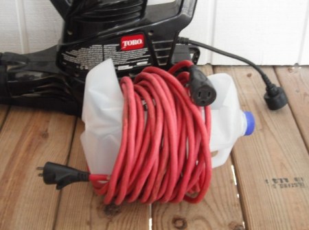 Leaf blower cord wrapped around a modified milk jug.