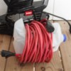 Leaf blower cord wrapped around a modified milk jug.