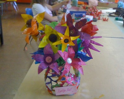 Flowers made from the bottoms of plastic bottles.