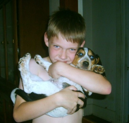 Boy holding a beagle puppy.