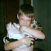 Boy holding a beagle puppy.