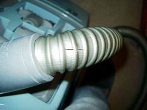 Torn vacuum cleaner hose.