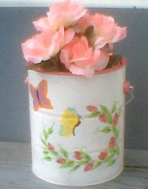 White paint can with spray of pink flowers and butterflies.