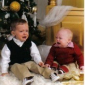 Two boys crying in front of tree