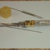 Pencil lead tube with a variety of sewing needles.
