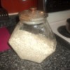Glass canister filled with oatmeal mix.