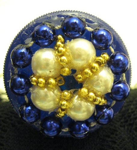 Blue, pearl, and gold beaded jar lid.