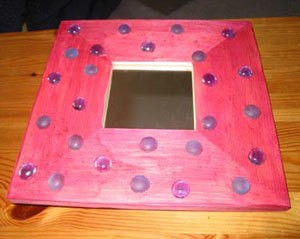 Pink painted mirror with flat glass beads.