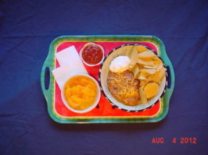 Tray with food on a dark blue background.