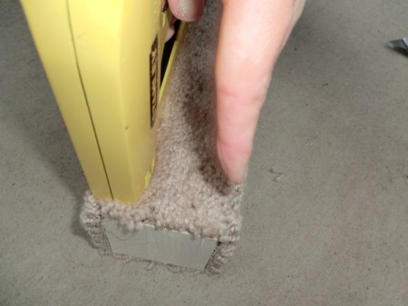 Stapling carpet to the cat scratching post.