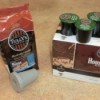 A bag of ground coffee beans and a refillable pod next to a box of Keurig coffee pods.
