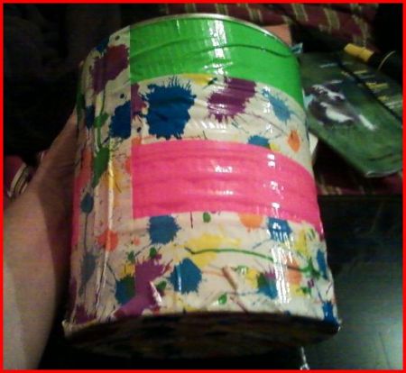 Can covered with floral and bright pink and green duct tape.