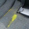 Photo of melted yellow crayon on a car seat.