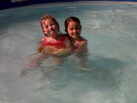 Two young children in a pool.