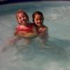 Two young children in a pool.