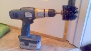 Toilet brush mounted on cordless drill.