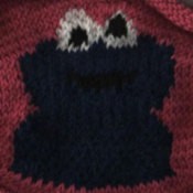 A knitted sweater with the Sesame Street character Cookie Monster.