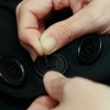 Closeup of Sewing Buttons On Clothing