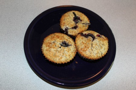 3 lemon poppy seed blueberry muffins on a plate
