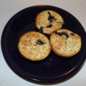 3 lemon poppy seed blueberry muffins on a plate