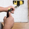 A person cleaning a rug.