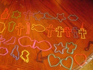A collection of brightly colored cookie cutters.