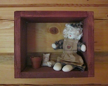 Fabric doll in shadow box.