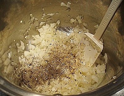 Onions being cooked before tomatoes.