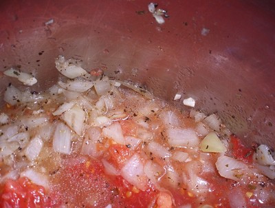 Tomatoes being added to pot.