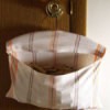 Tea towel on wooden hanger clothespin bag.