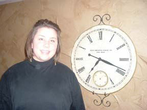 Teen girl next to clock.