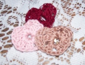 Crocheted hearts in 3 colors.