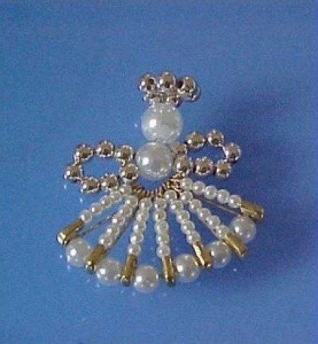 Angel pin in gold, silver, and pearl.