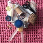A pin that shows a love of sewing, with lots of buttons and notions displayed.