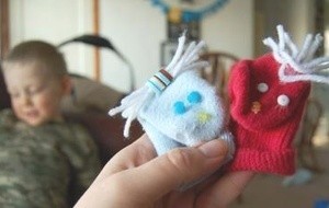 Two sock puppets made from baby socks.