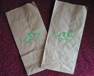 Dinosaur stenciled brown paper bags.