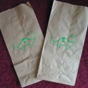 Dinosaur stenciled brown paper bags.