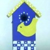 Decorative blue and yellow birdhouse.