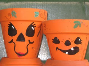 Clay pots decorated with Jack-O-Lantern Faces