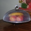 Mesh screen dome cover over fruit.