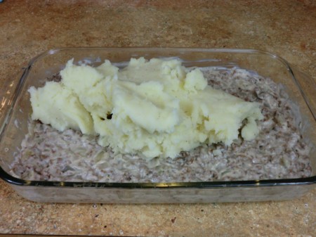 spoon potatoes onto meat mixture