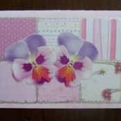 Special occasion card with pink patchwork pink squares and pansies.