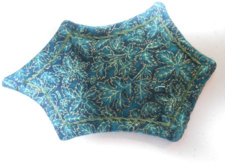 Outline embroidery stitching on leaf.