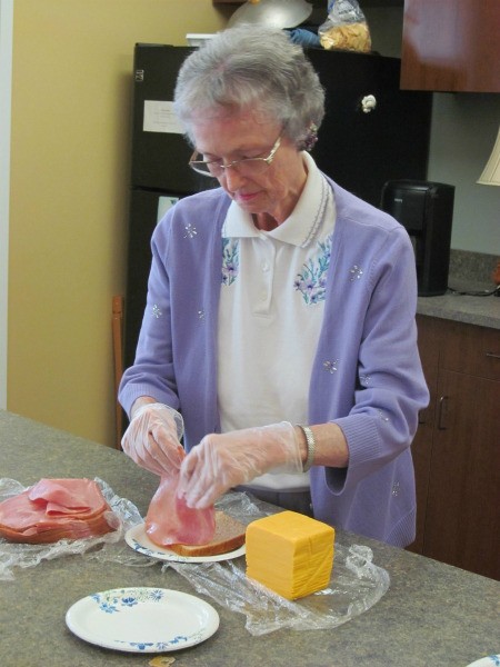 A photo of Wava working with food in the kitchen.