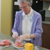 A photo of Wava working with food in the kitchen.